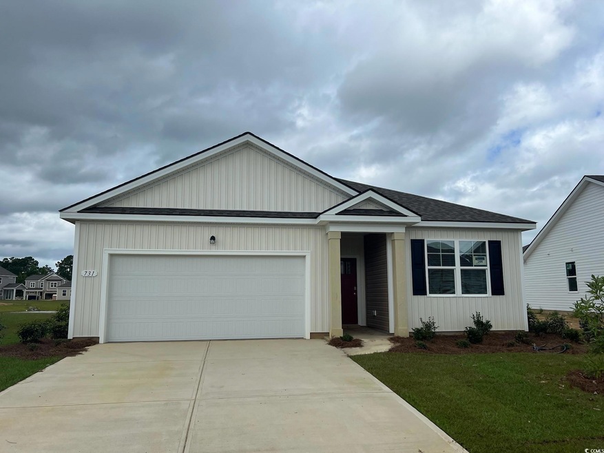 Ranch-style home featuring a garage, concrete driveway, a shingled roof, and a front yard