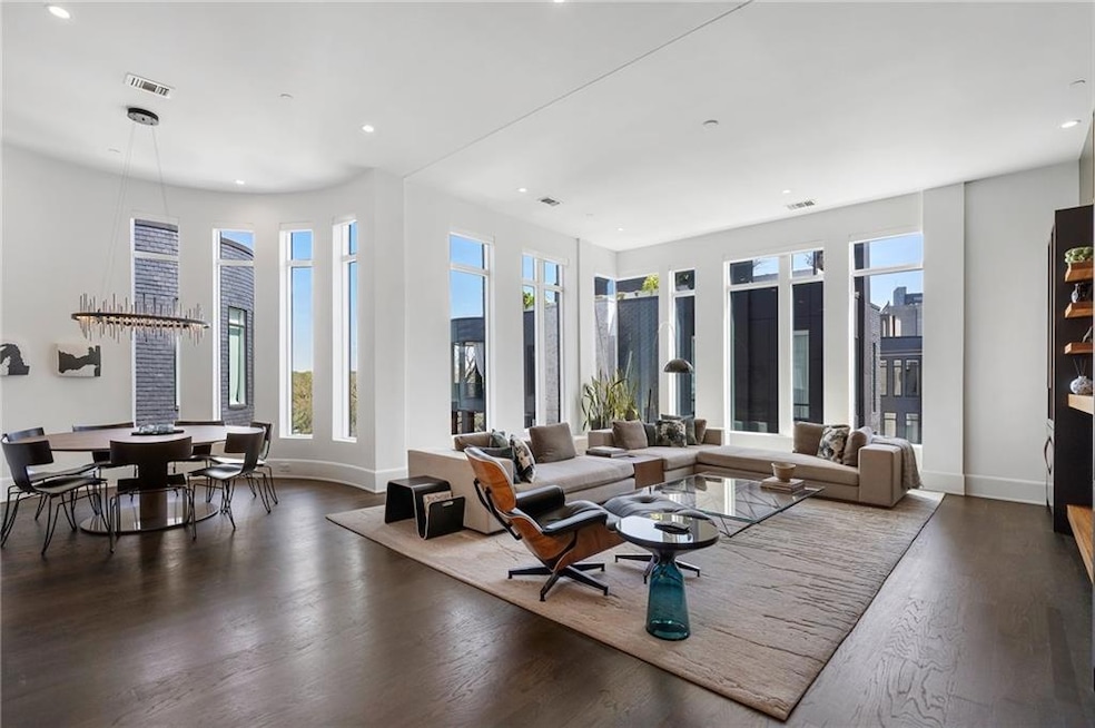 Living room with visible vents, wood finished floo