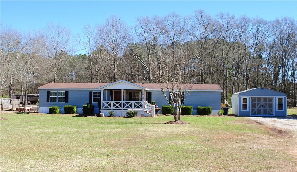 Front of home with workshop to the right. Welcomin