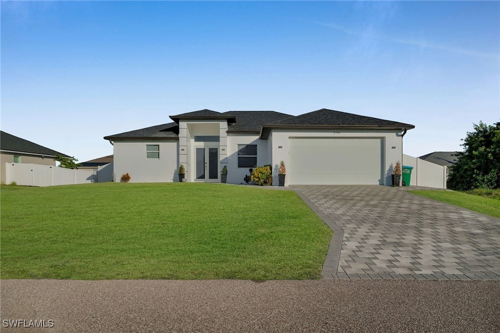 View of front of house with a garage and a front l