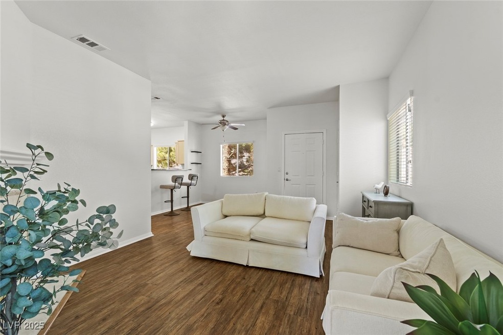 Living area with visible vents, wood finished floo