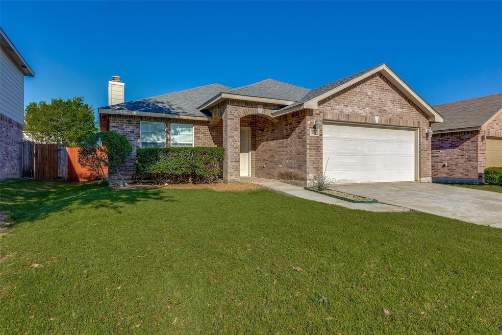Single story home with a front lawn and a garage