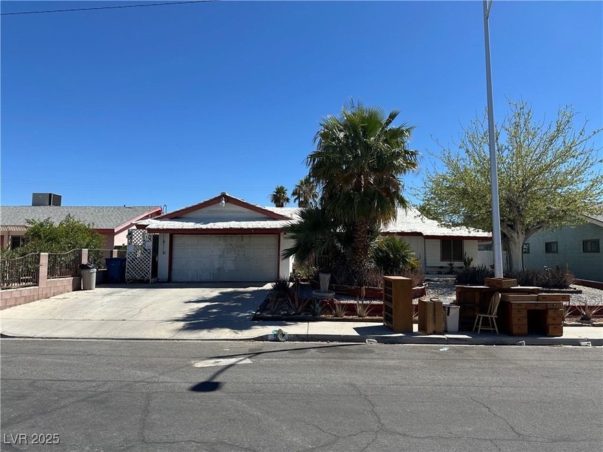 Single story home with fence, a garage, and concre