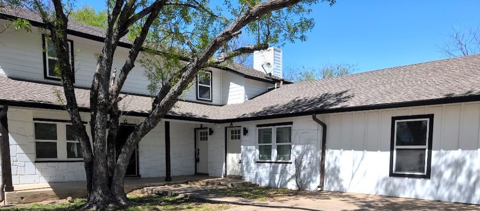 View of front of property with a chimney and a sh