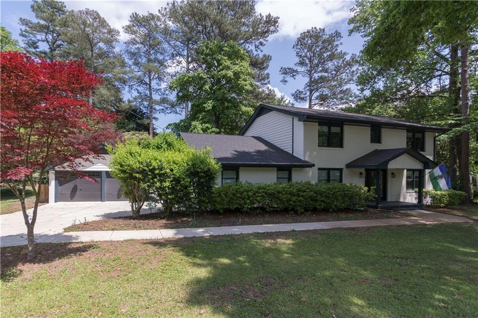 View of front of house with a garage and a front y