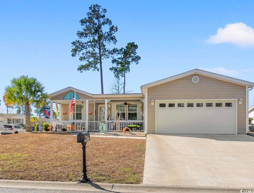 Ranch-style home with a garage and a porch