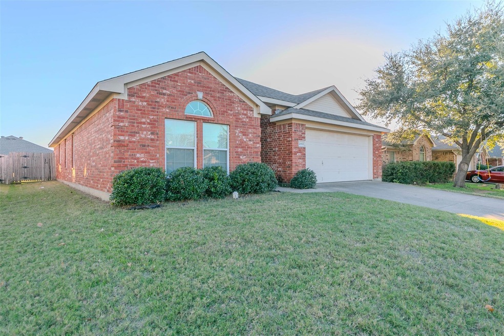 View of front of home with a front lawn and a 2 ca