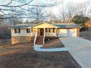 Single story home featuring a porch and a garage