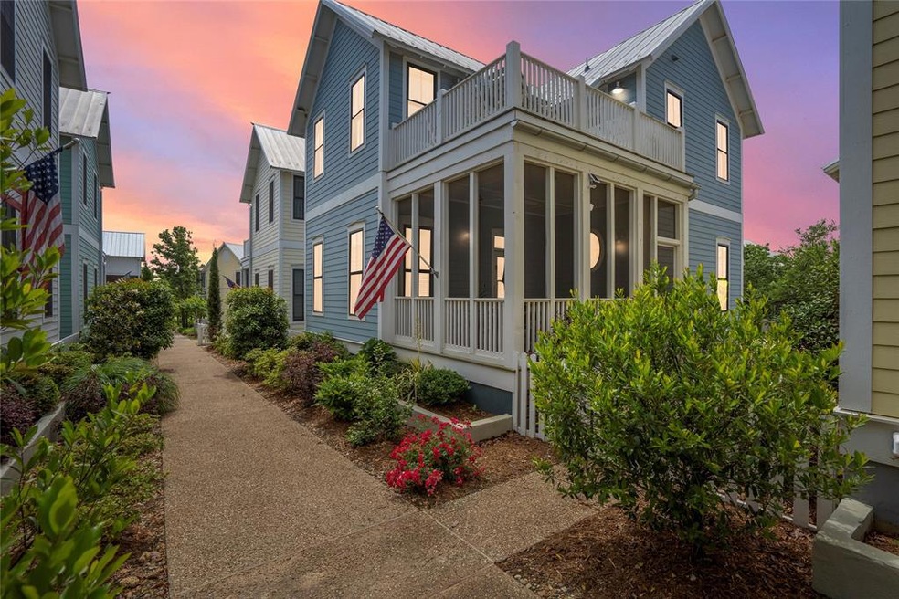 View of front of house featuring a balcony and a s