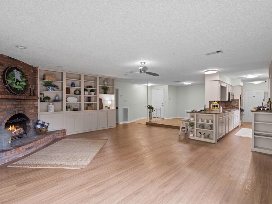 Enter this home to an open-concept living area, wi