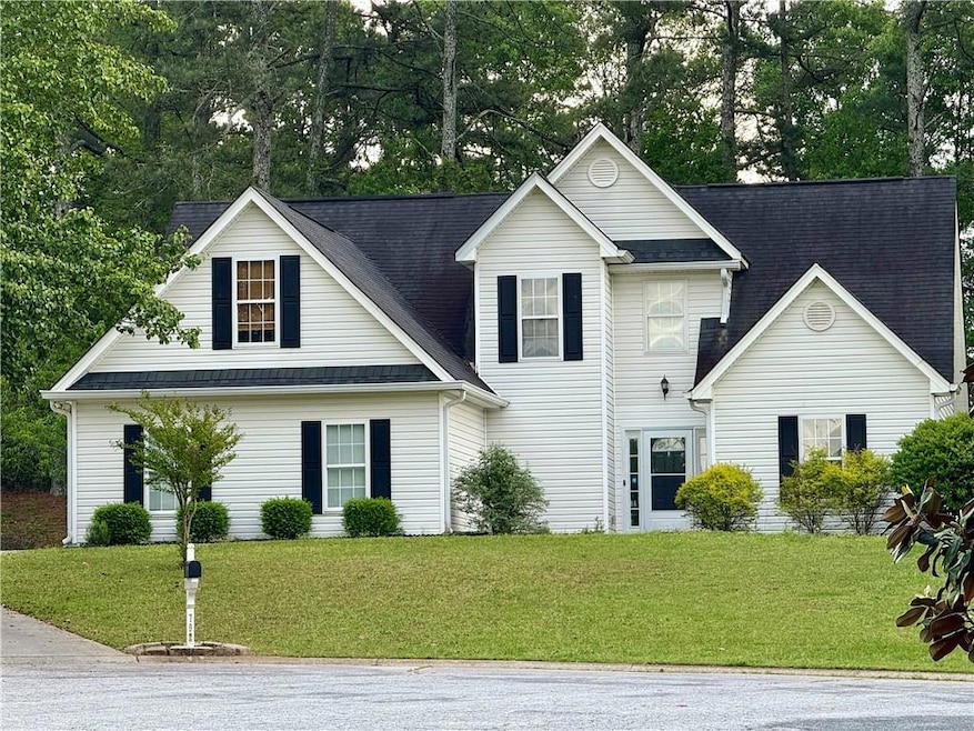 Traditional-style house featuring a front lawn