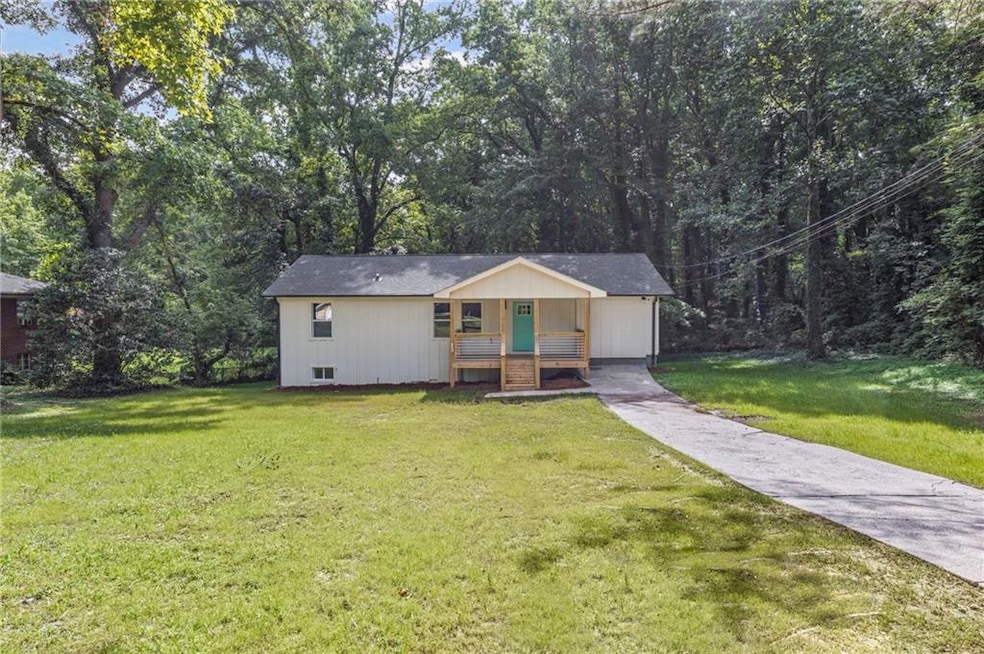 Ranch-style home with covered porch, a front lawn, and concrete driveway