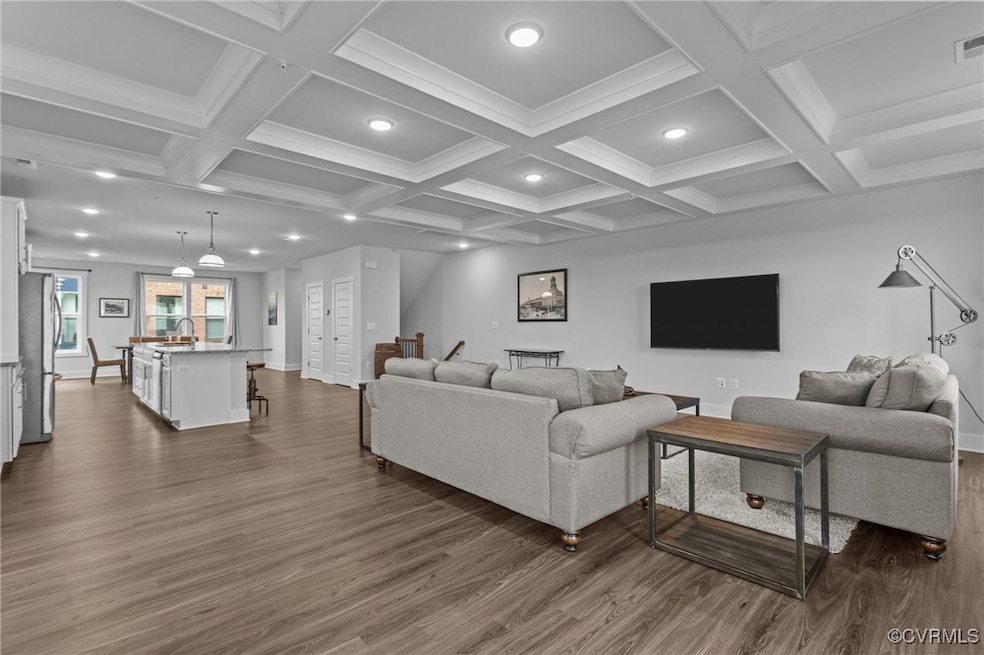 Living area featuring dark wood finished floors, r