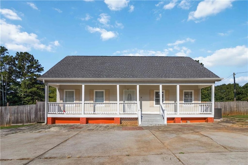 View of front of house featuring a shingled roof and a porch