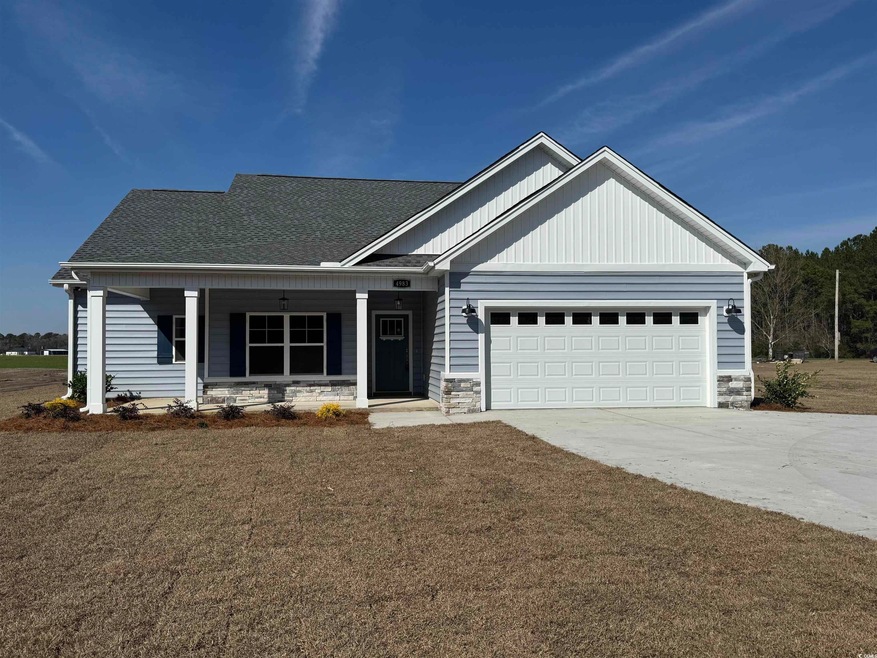 View of front of house featuring a garage, concret
