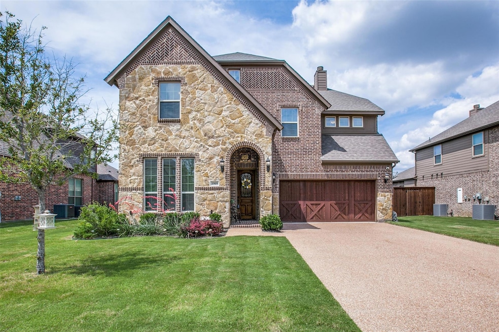 View of front of house with a front lawn, a garage