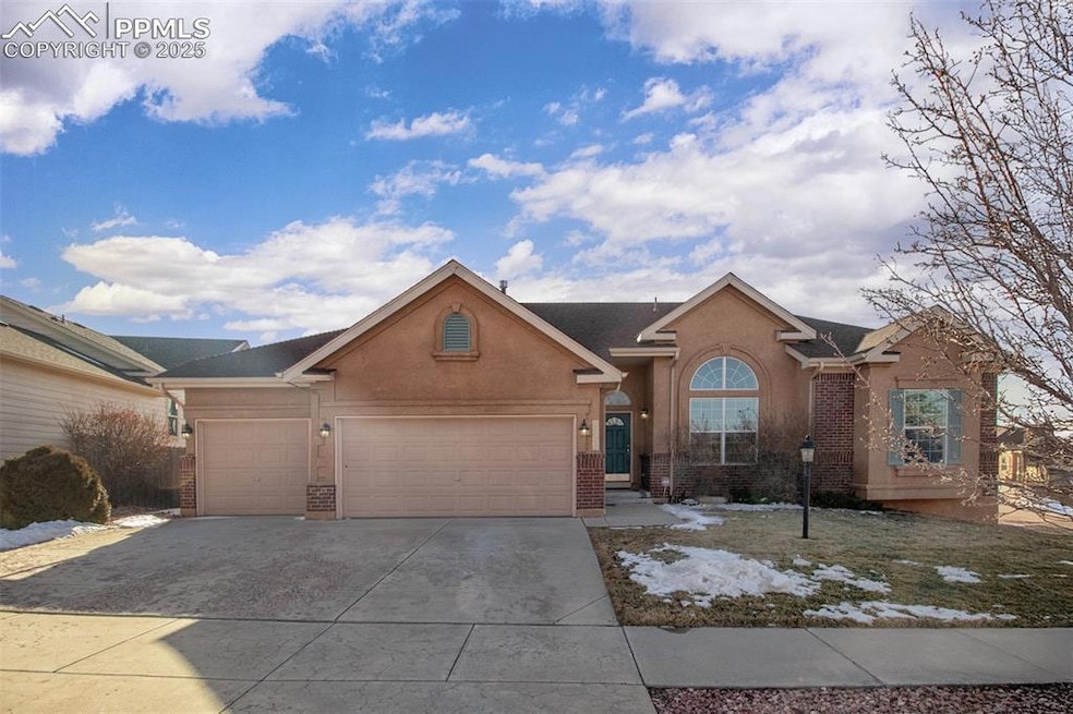 Ranch-style house featuring stucco siding, drivewa