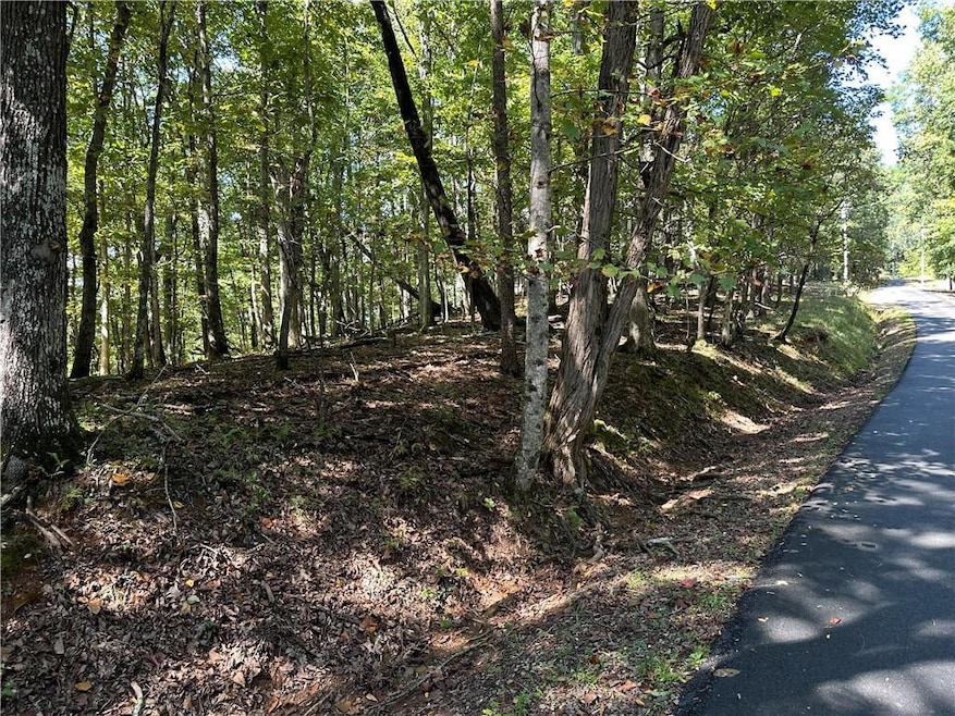 This 1.47 acre lot is in Bent Tree, Jasper, GA.  This lot sits close to the back gate, and will have seasonal views once the lot is cleared for building. This lot will lend well to a basement floor plan.