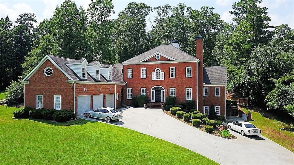 4 Sides brick executive style home on 1 fenced acr
