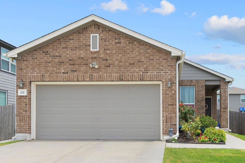 Ranch-style house with driveway, brick siding, and an attached garage