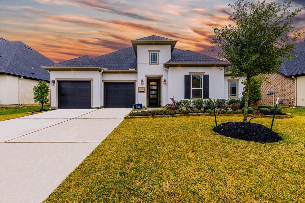 Welcome home to 2231 Harstad Manor Drive located in The Reserve at Katy and zoned to Katy ISD. This stunning home has lovely curb appeal, a well-manicured lawn, beautiful landscaping, stucco elevation, dark stained front door with glass detailing, covered front entryway, dark stained shutters, beautiful outdoor lanterns, and a double wide driveway.