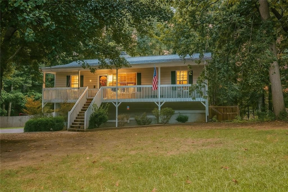 View of front facade featuring covered porch and stairs