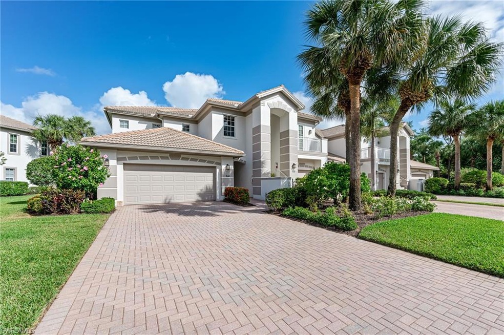 Mediterranean / Spanish house with stucco siding, decorative driveway, a front yard, a tile roof, and a 2-garage