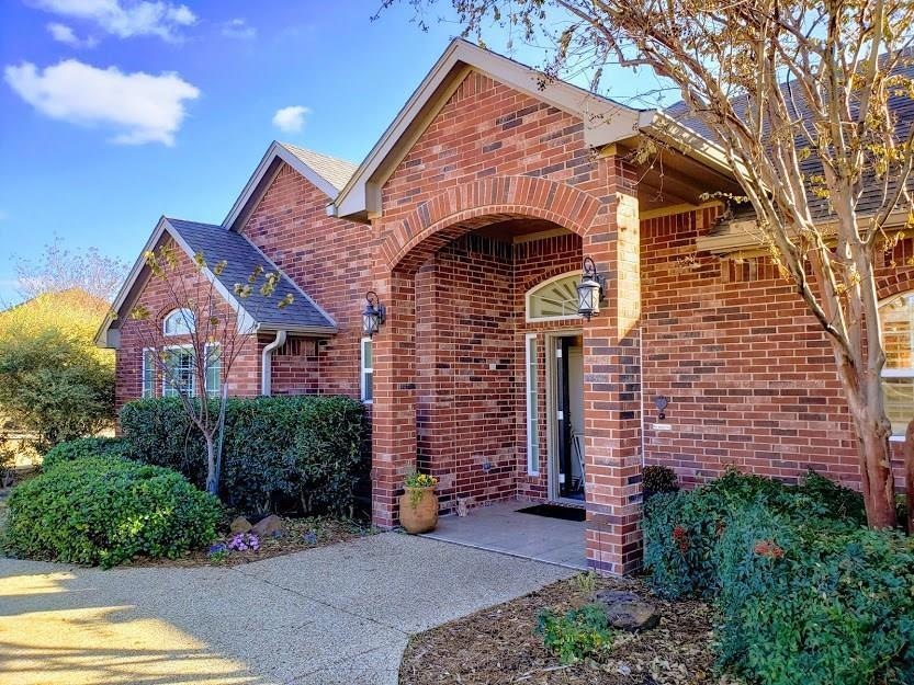 Doorway to property featuring brick siding