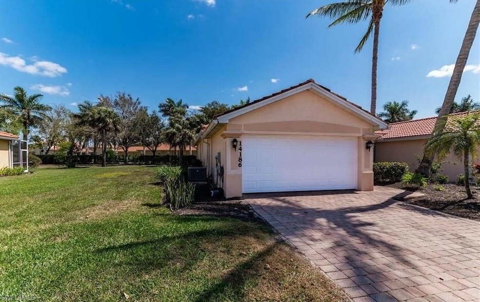 View of property exterior with stucco siding, decorative driveway, a yard, and an attached garage