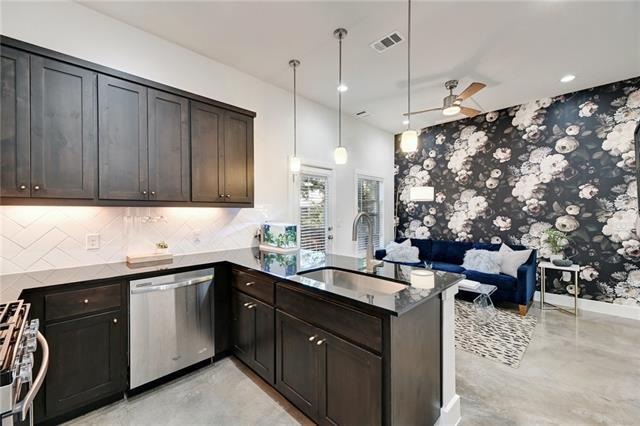 The modern kitchen is open to the living room and 