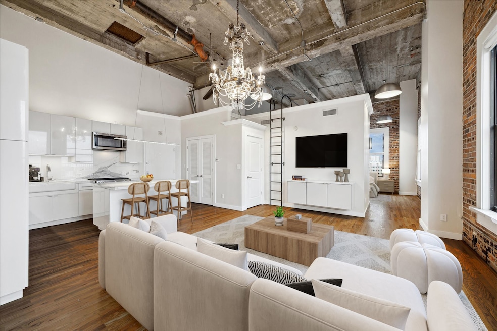 Experience elevated downtown living in this fully renovated corner penthouse loft at Bayou Lofts. Virtually staged living room
