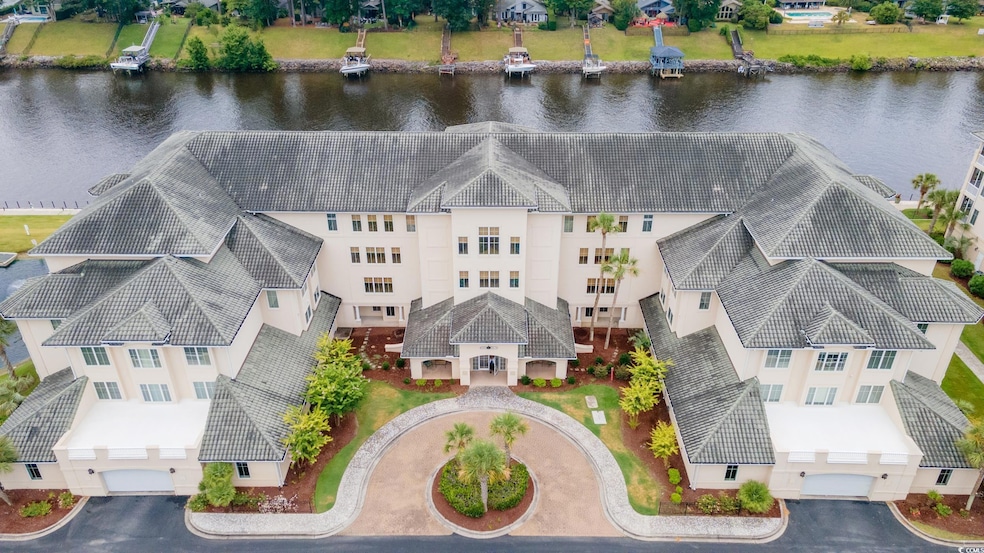 Birds eye view of property with a water view