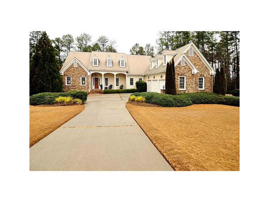 Exterior Front. Expansive lawn frames this custom 