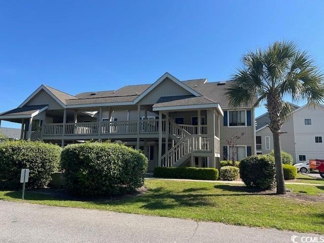 View of front of property with a front lawn and st