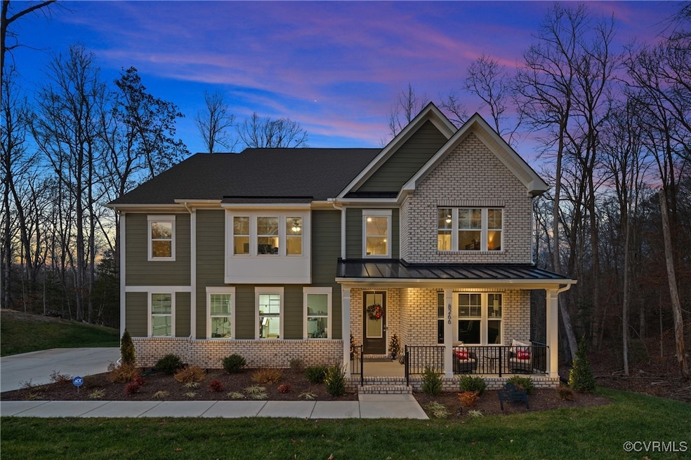 View of front facade featuring a porch and a yard