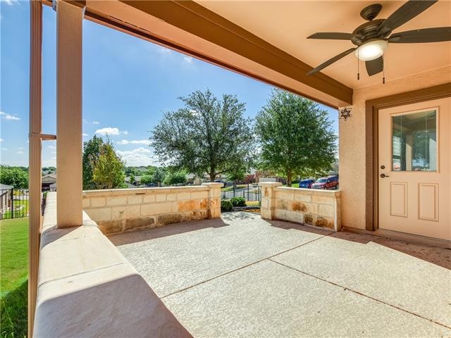 An East-facing extended back patio includes a Kool Kote finish with a limestone seating wall.