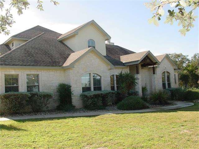 Front of home with all the stone and landscaping
