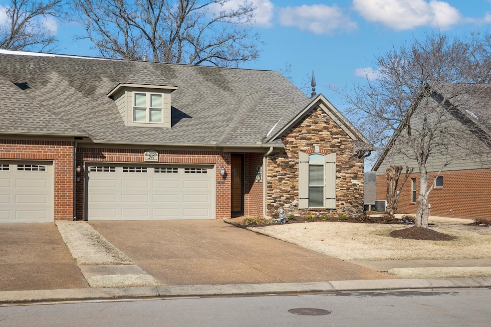 View of front of house featuring a garage, concret