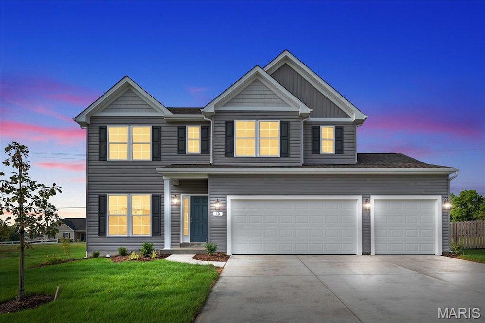 View of front of home featuring driveway, an attached garage, and board and batten siding