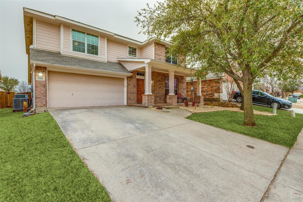 View of front of home featuring driveway, an attac