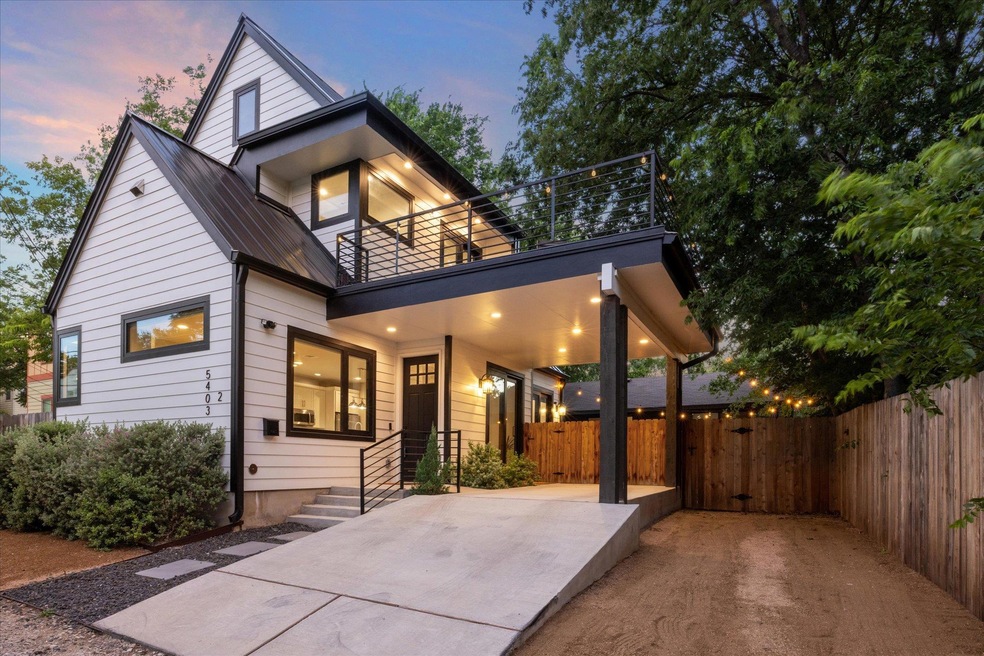 Contemporary home with a balcony and a metal roof