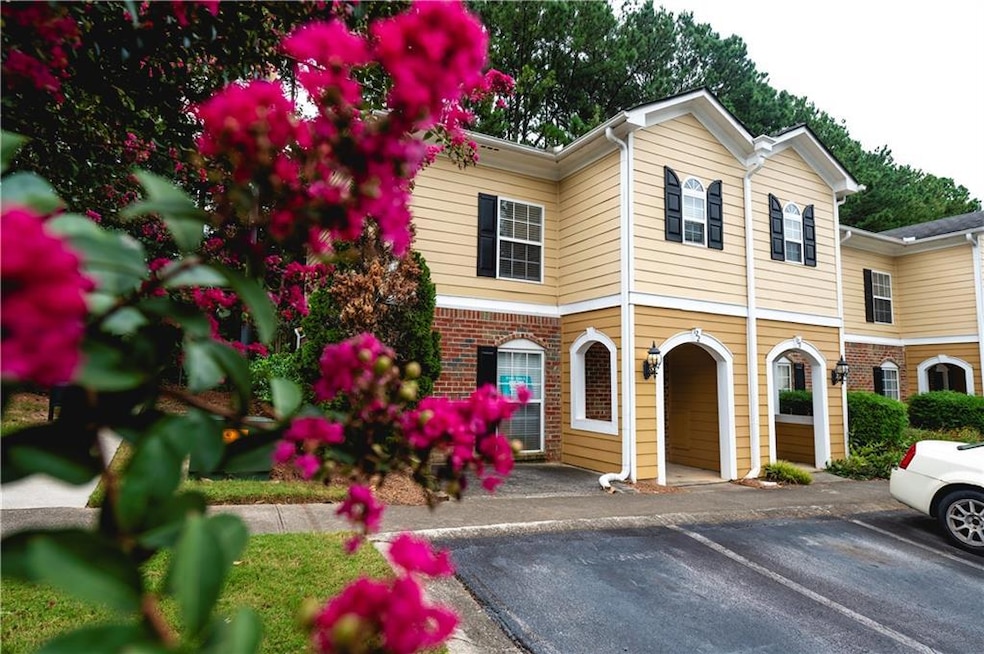View of front of house with uncovered parking and brick siding