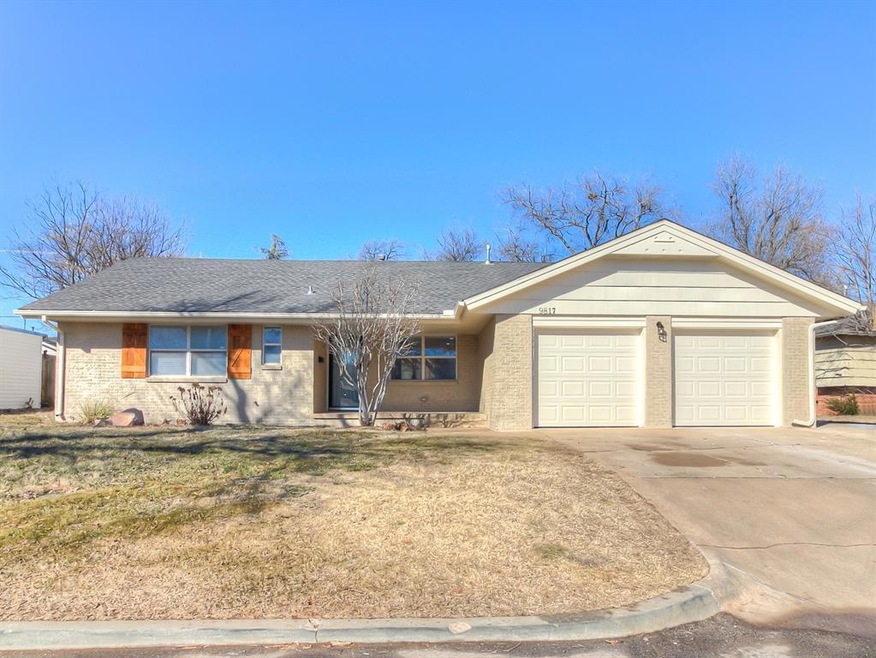 Ranch-style home featuring a garage and a front ya