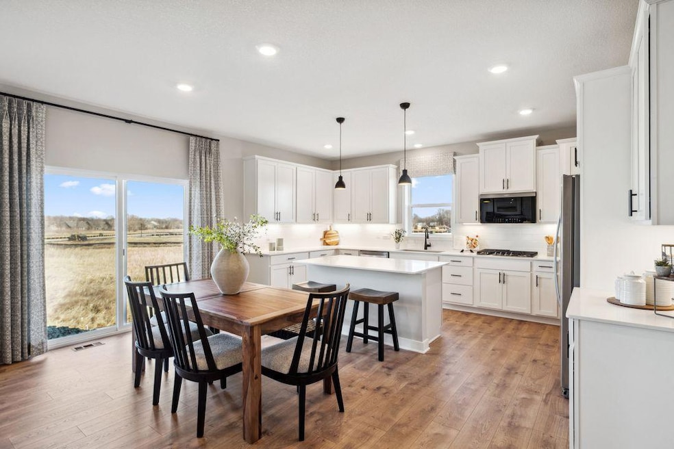 The open layout provides an optimal area to cook and entertain. Envision gathering together with friends and family in the heart of this home over the holidays! Photo is of previously built model home, finishes, selections, and colors may vary.