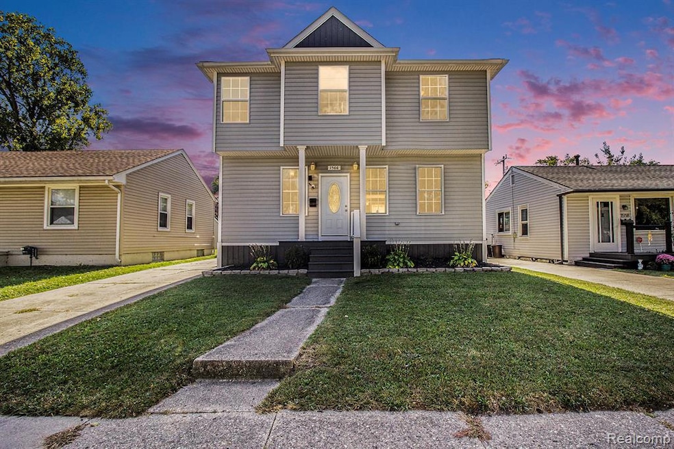 Colonial inspired home with a lawn