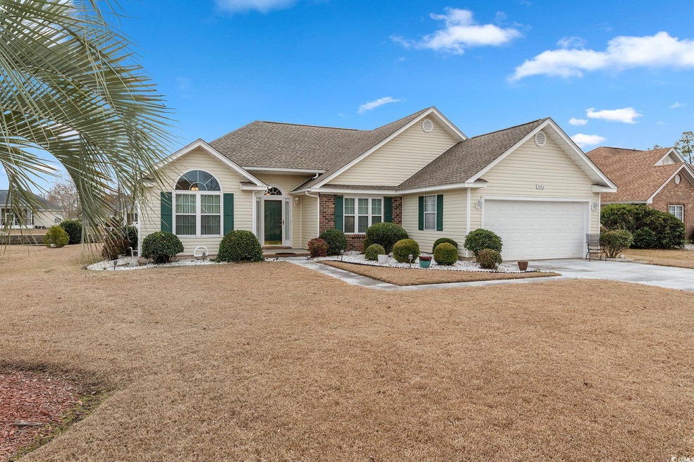 Ranch-style house featuring a garage, driveway, a 