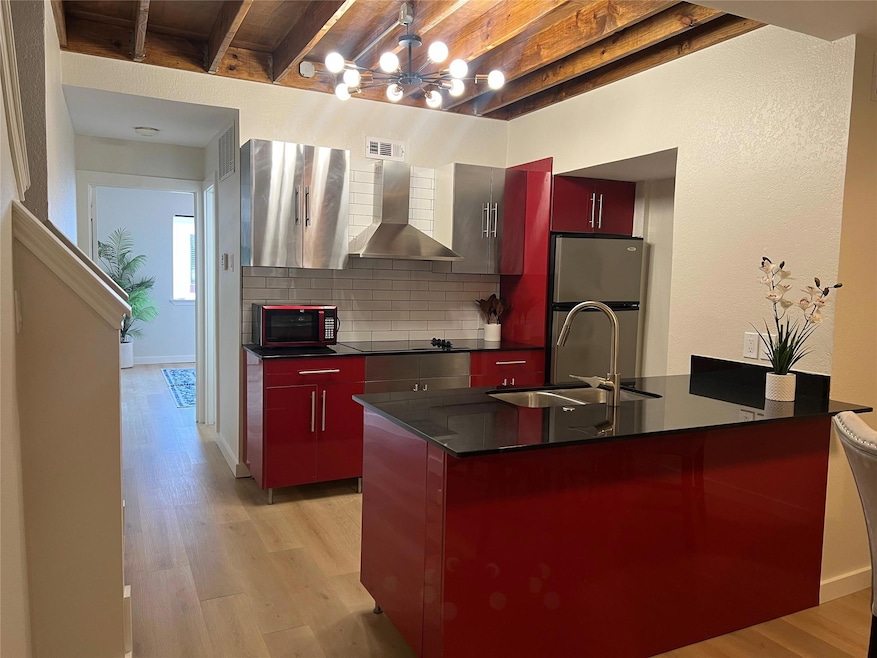 Kitchen featuring a center island with sink, sink,