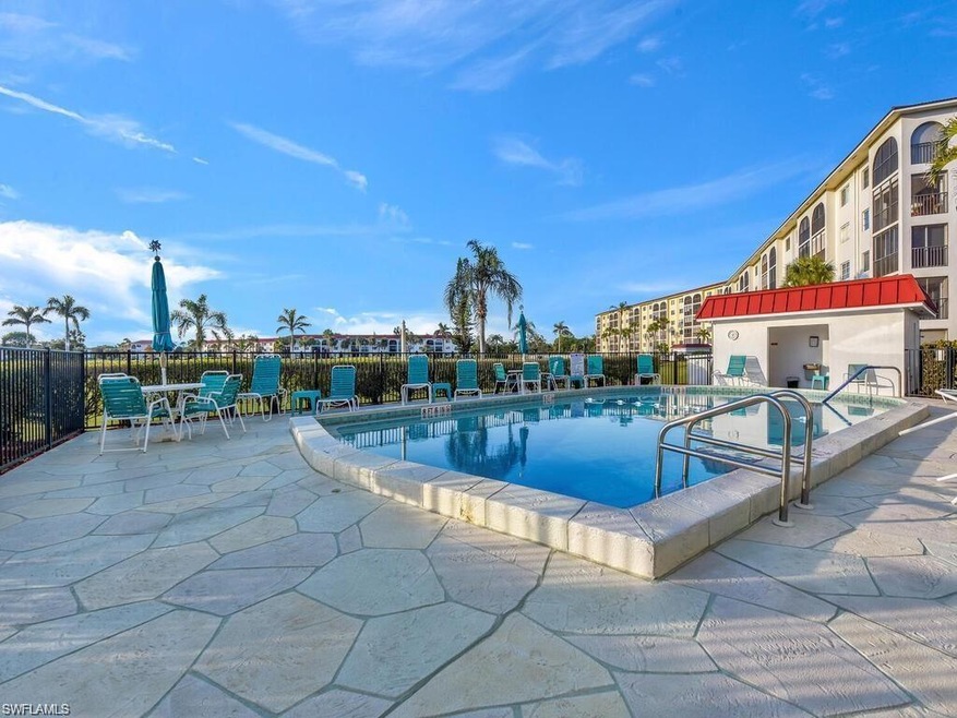 Community pool featuring a patio area and fence