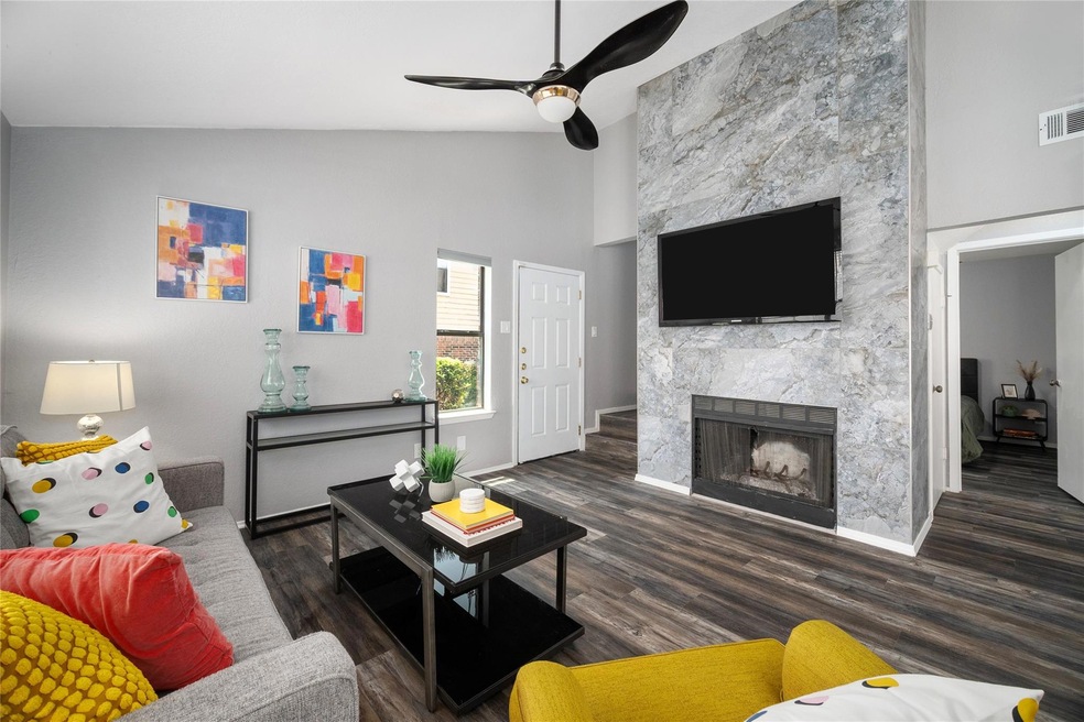 Living room with lofted ceiling, hardwood / wood-s