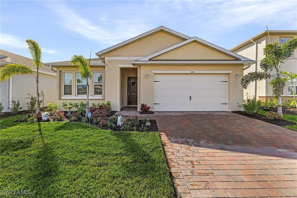 Ranch-style house featuring a garage and a front l